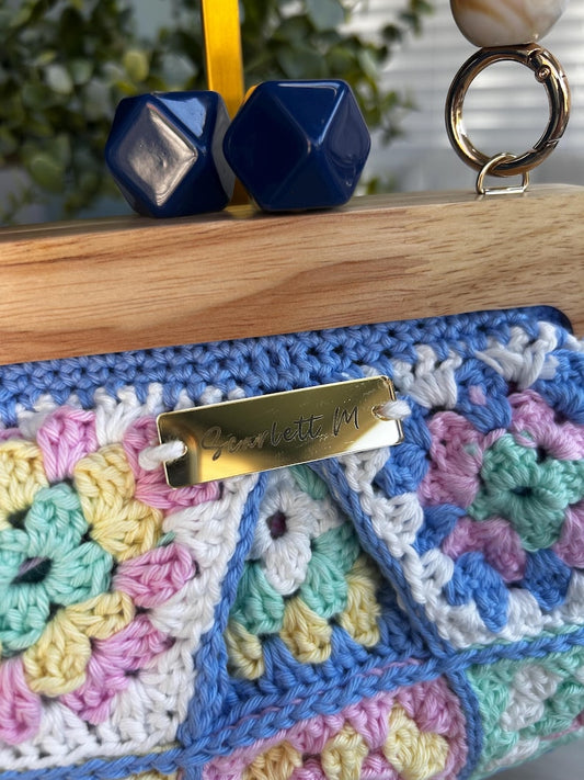 Pastel granny square clutch with Scarlett M tag