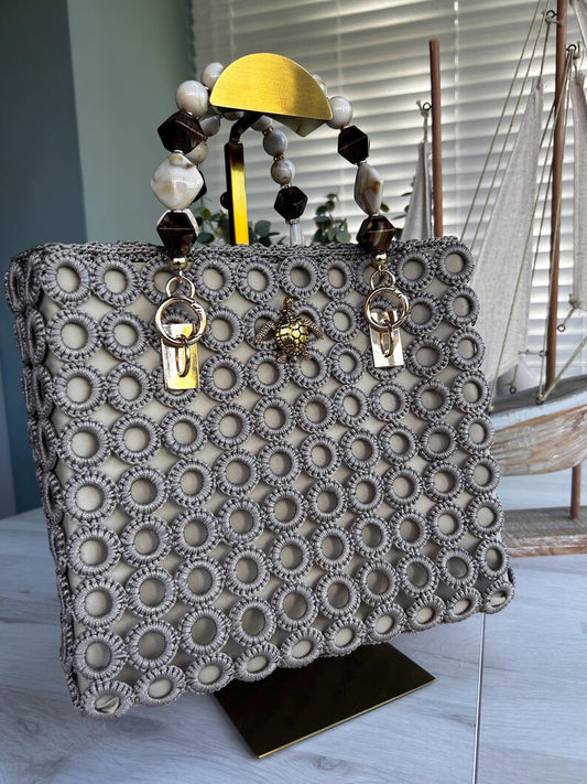 Handcrafted beige tote with circular crochet pattern and gold handle