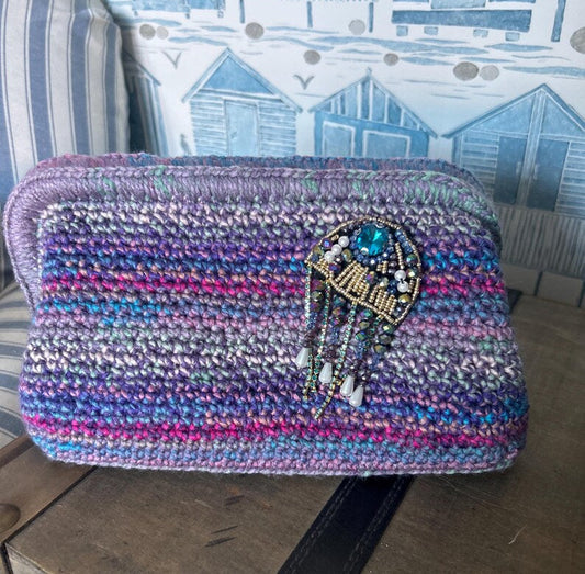 Ocean-toned crochet clutch with blue gemstone beaded embellishment