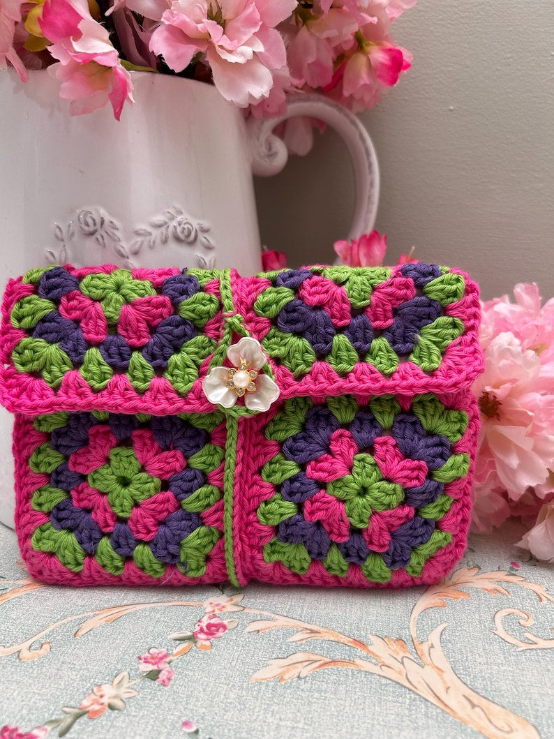 Pink, green and purple granny square crochet pouch with flower button