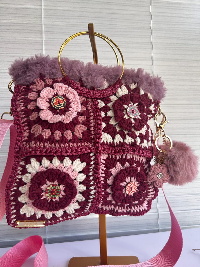 Side view of the floral crochet bag with gold handles