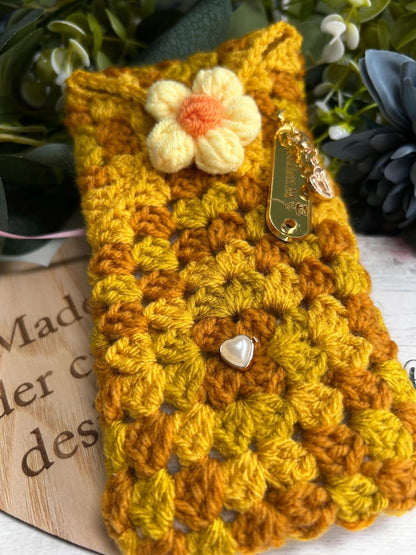 Yellow and orange crochet case with flower applique