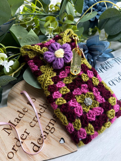 Burgundy and pink granny square crochet case with purple flower