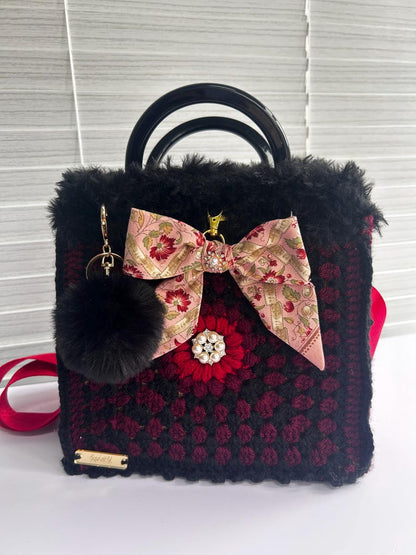 Side view of the burgundy crochet tote bag