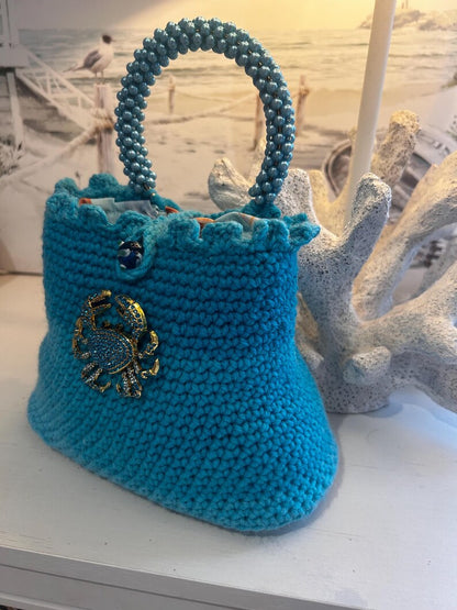 Turquoise blue crochet bag with scalloped top and crab charm
