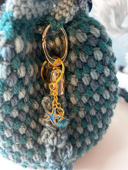 Crochet bag with gold keyring and starfish and shell charms