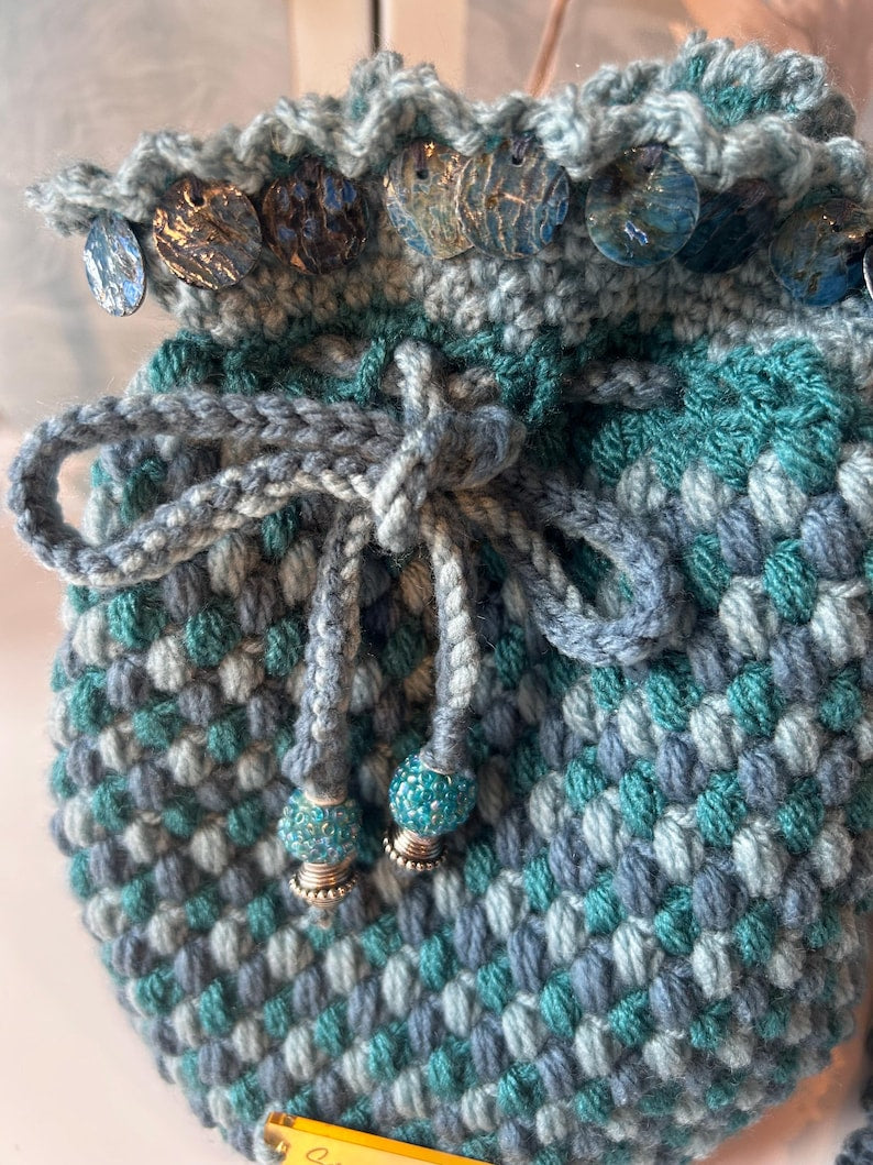 Variegated teal drawstring pouch with ruffled trim