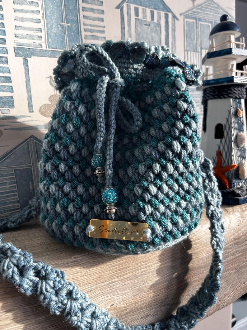Teal crochet drawstring bag with Scarlett M tag