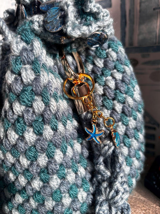 Crochet drawstring bag with starfish and seashell charm