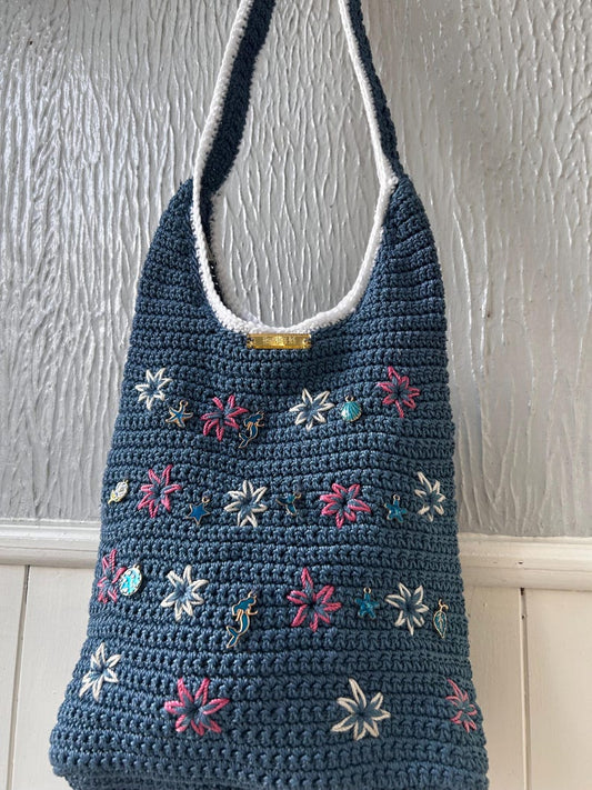 Blue crochet bag with embroidered star flowers and sea charms