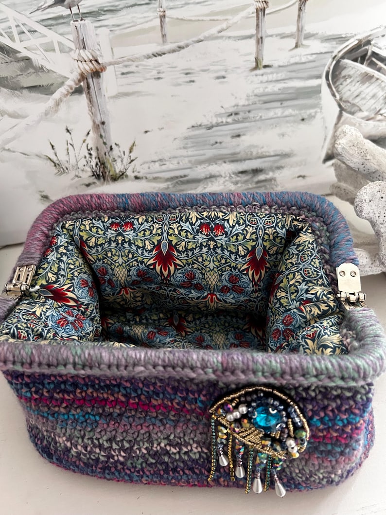 Rectangular crochet purse with floral lining and gem clasp