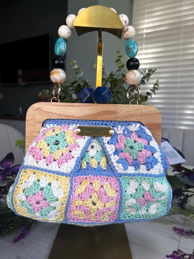 Pastel floral crochet clutch with wooden frame and beaded handle