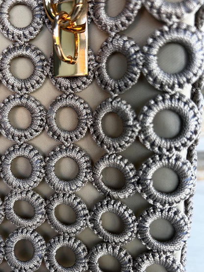 Beige tote with gold clasp and patterned gray crochet circles