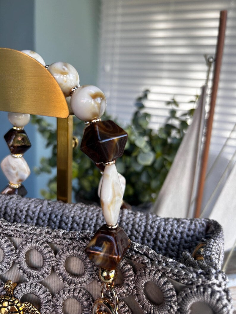 Close-up of beaded handle with white and brown marbled beads