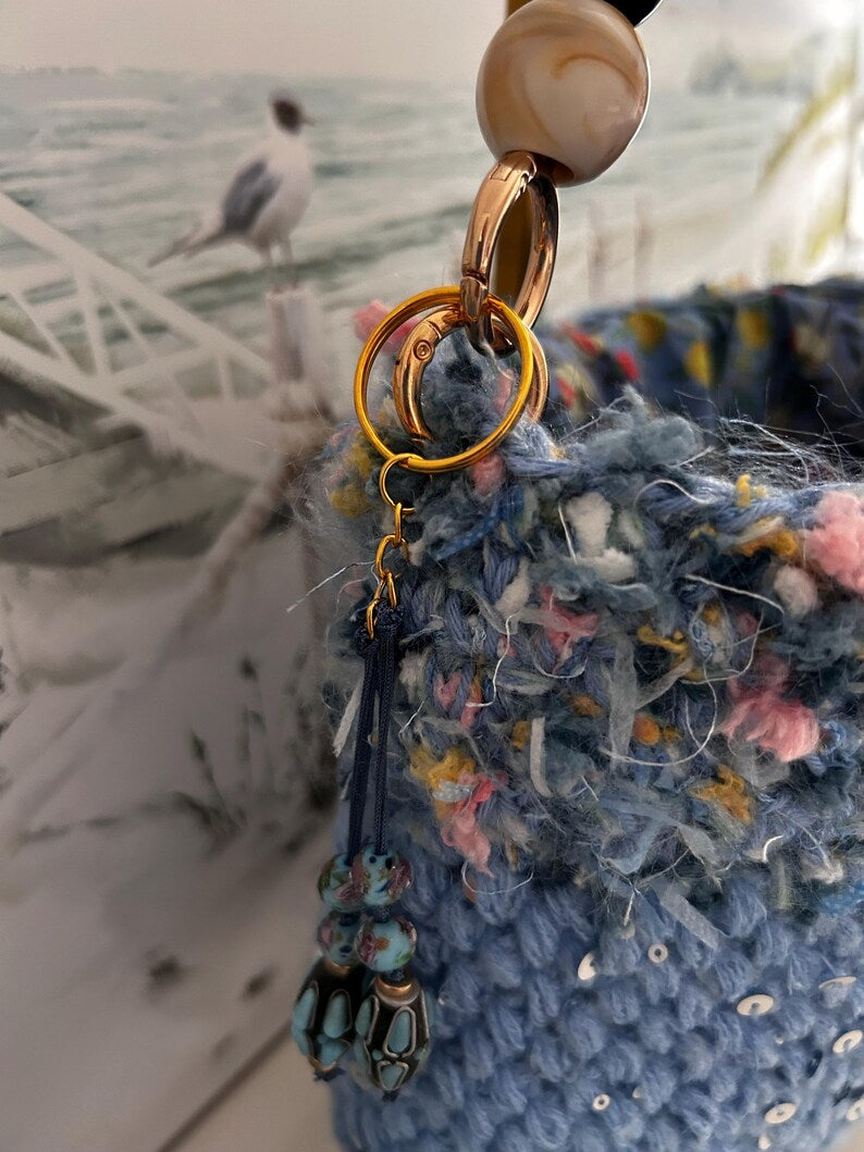 Blue crochet bag with sequins and decorative beaded charm