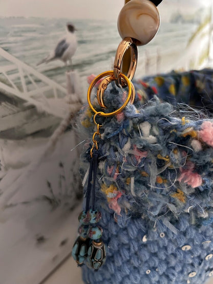 Blue crochet bag with sequins and decorative beaded charm