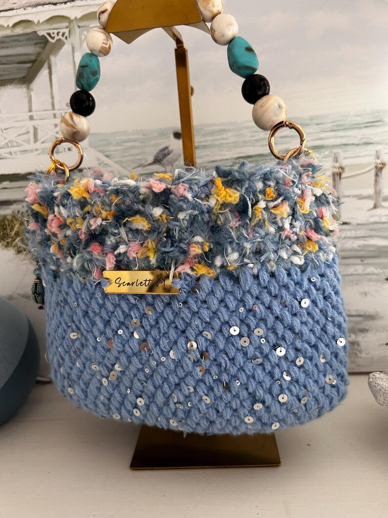 Light blue crochet bag with fringe top and Scarlett M metal tag