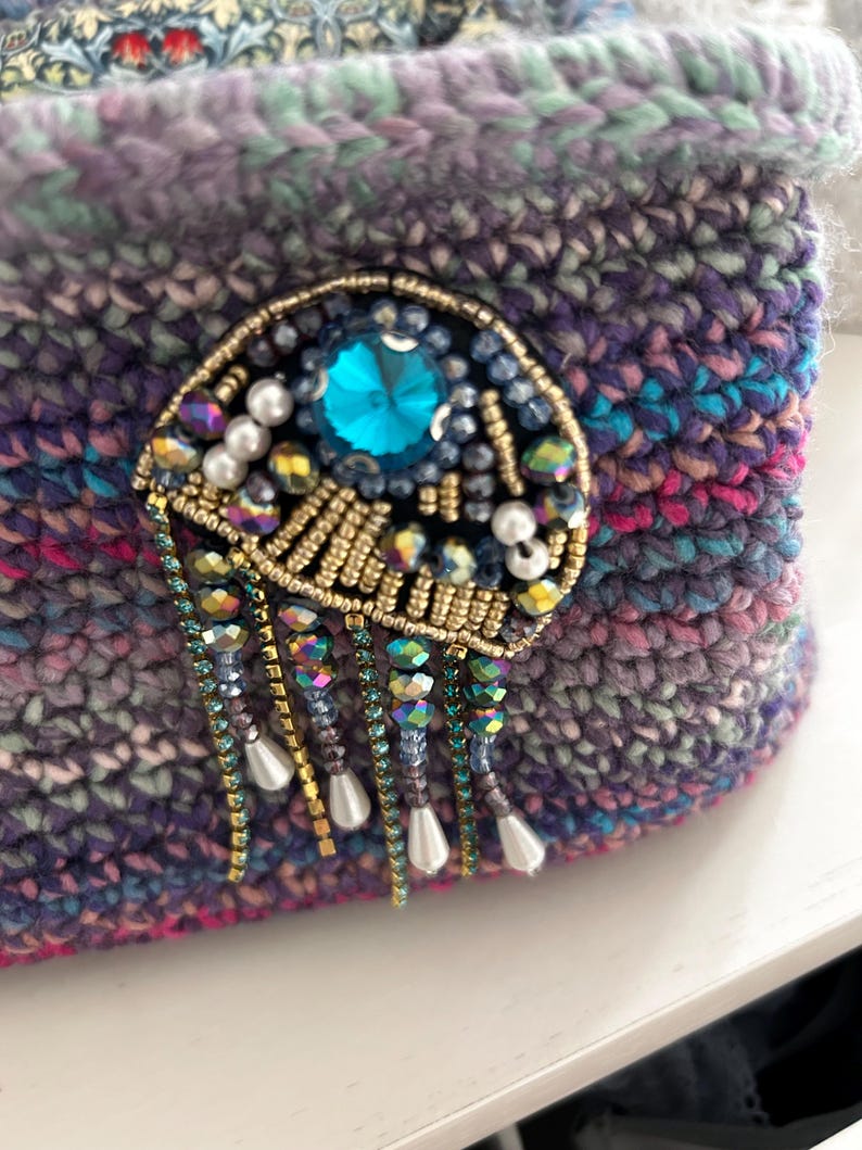 Purple and blue crochet bag with pearl and gemstone embellishment