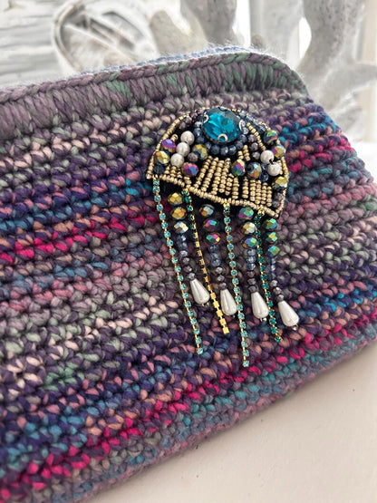 Multicolour crochet clutch with jeweled brooch and crystal strands