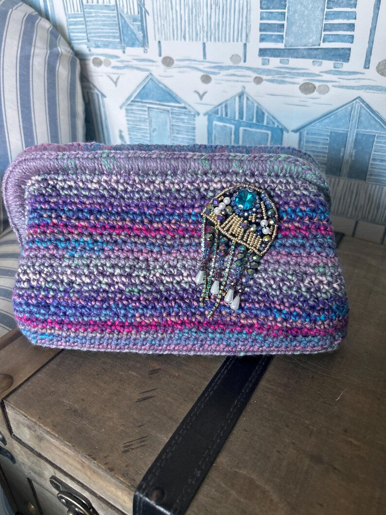 Ocean-toned crochet clutch with blue gemstone beaded embellishment