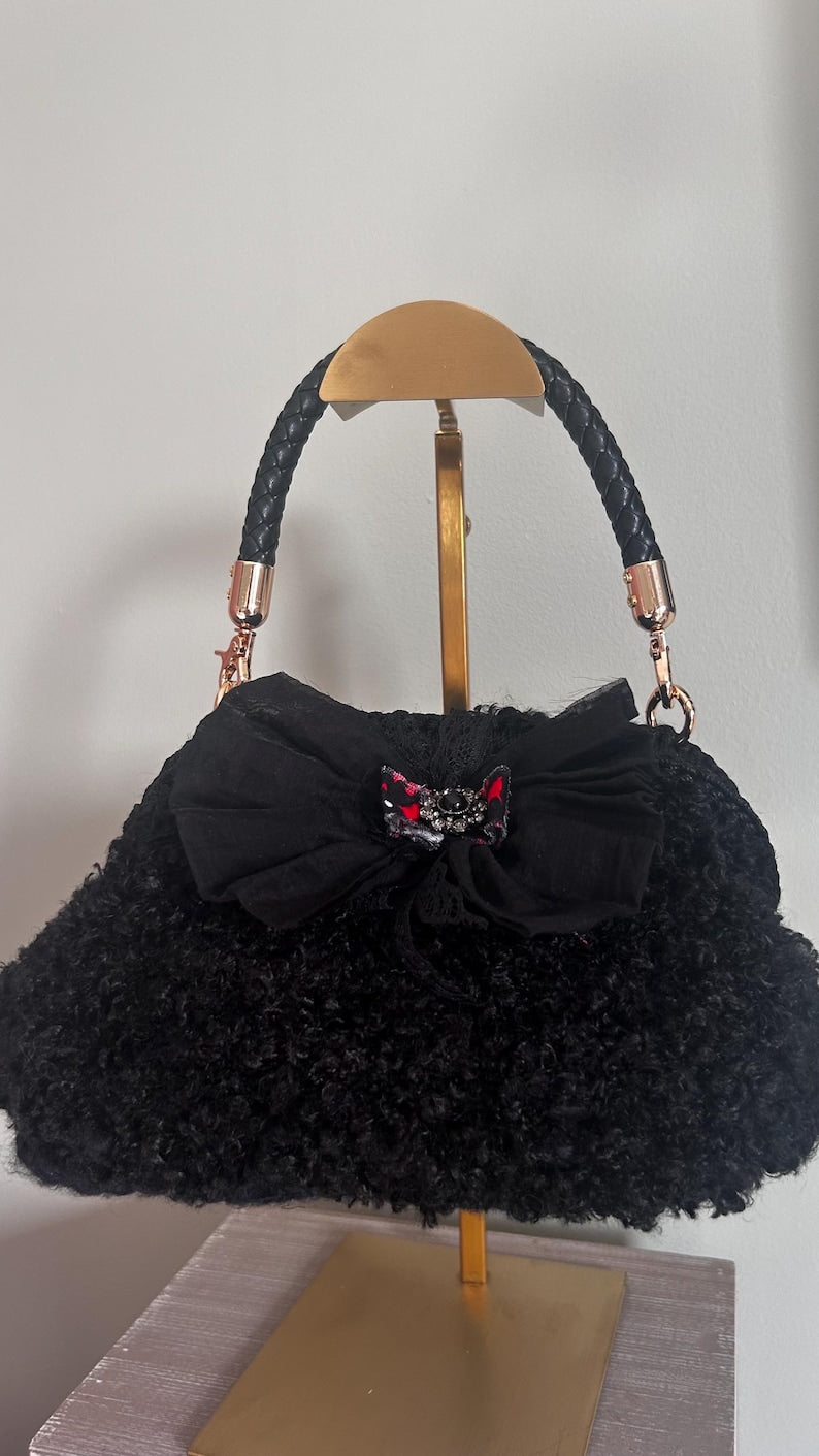 Black handbag with bow and braided handle
