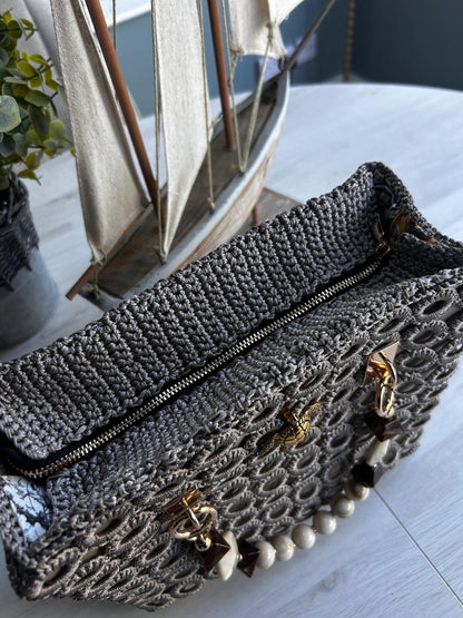 Gray crochet handbag with gold hardware and beaded accent