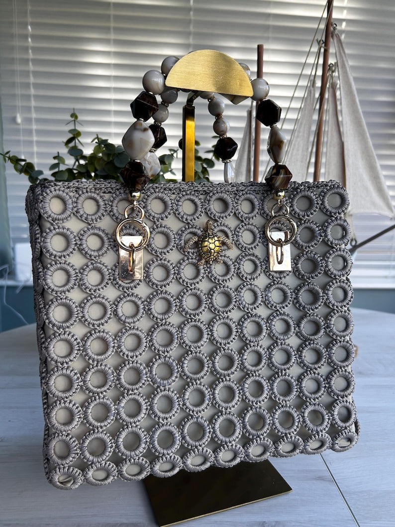 Gray crochet statement tote with pearl bead handles and gold turtle charm