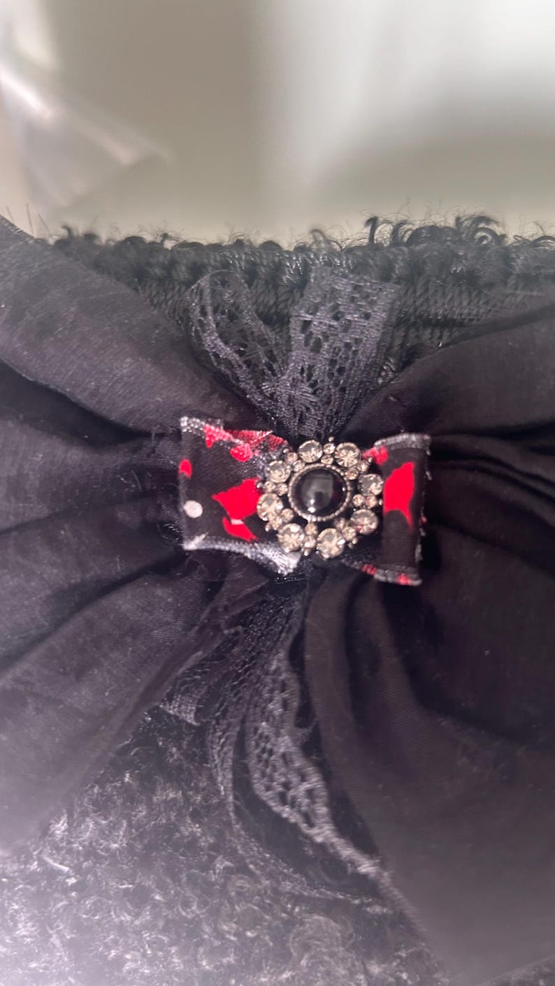 Close-up of black bow with rhinestone brooch