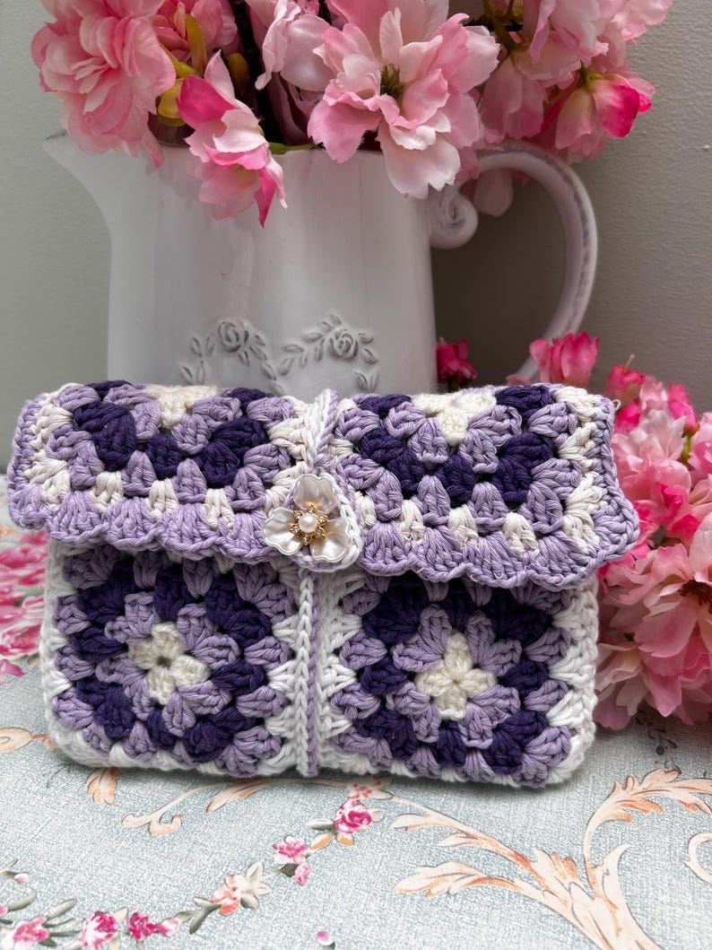 Purple and lavender granny square crochet pouch with floral button