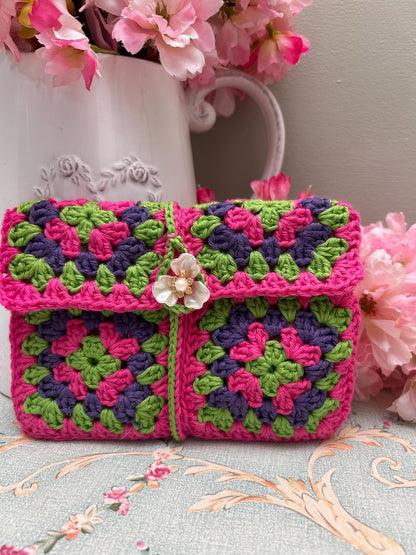Pink, green and purple granny square crochet pouch with flower button