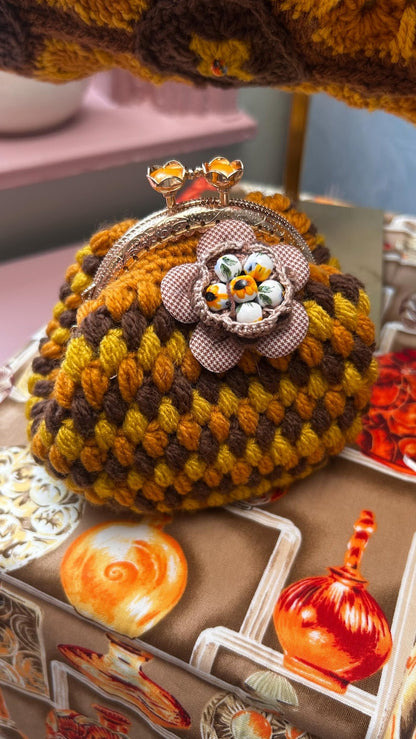 Round mustard crochet coin purse with kiss-lock clasp and flower
