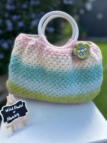 Pastel gradient crochet handbag with green flower