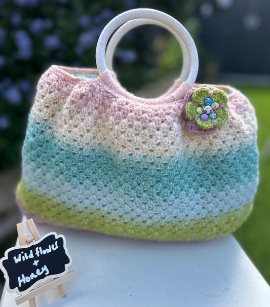 Pastel gradient crochet handbag with green flower