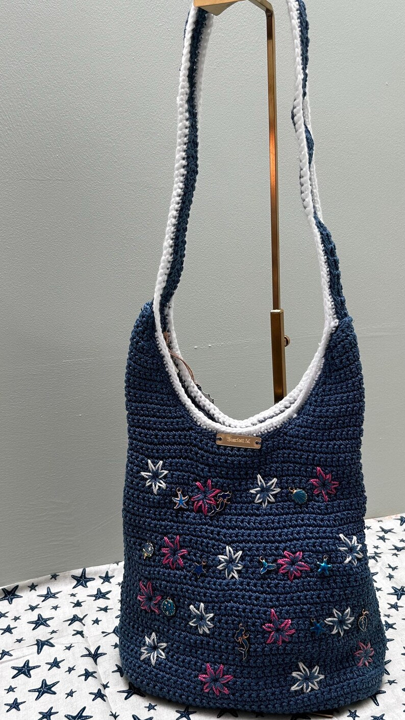Blue crochet hobo bag with star and floral charms